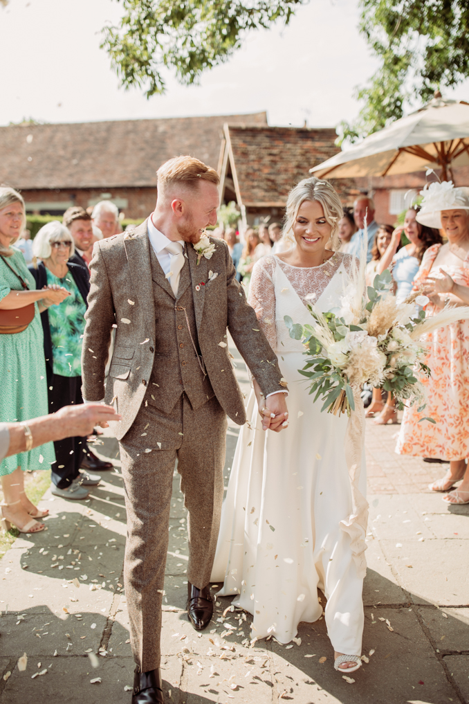 bride and groom confetti photo at winters barns wedding venue in kent