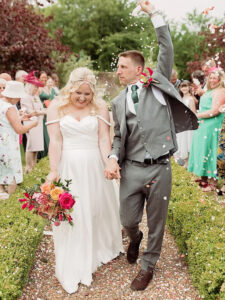 bride and groom with confetti at the secret garden